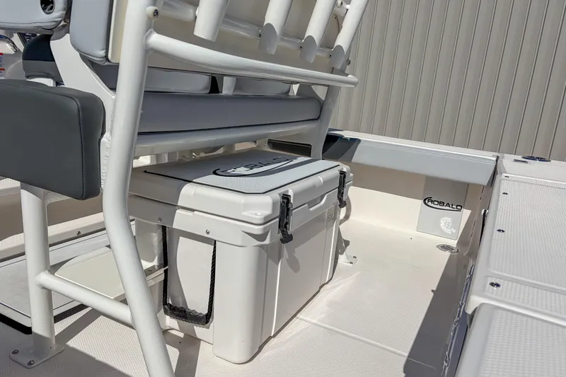 Slide: The Image of 2025 Robalo 226 Cayman boat interior with seating and storage cooler. - 5