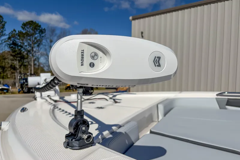 Slide: The Image of 2025 Robalo 226 Cayman boat with Minn Kota Terrova trolling motor, outdoor setting. - 9