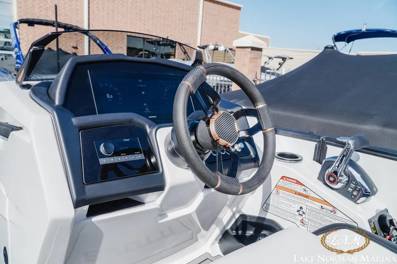 Slide: The Image of Cockpit of 2026 Evotti 723CS boat with modern steering and controls at Lake Norman Marina. - 10