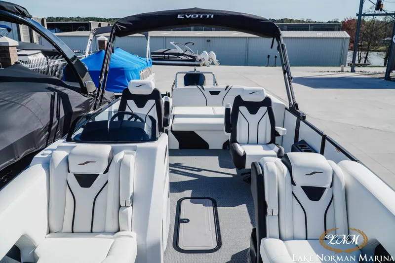 Slide: The Image of 2026 Evotti 723CS boat with sleek white seating at Lake Norman Marina. - 12