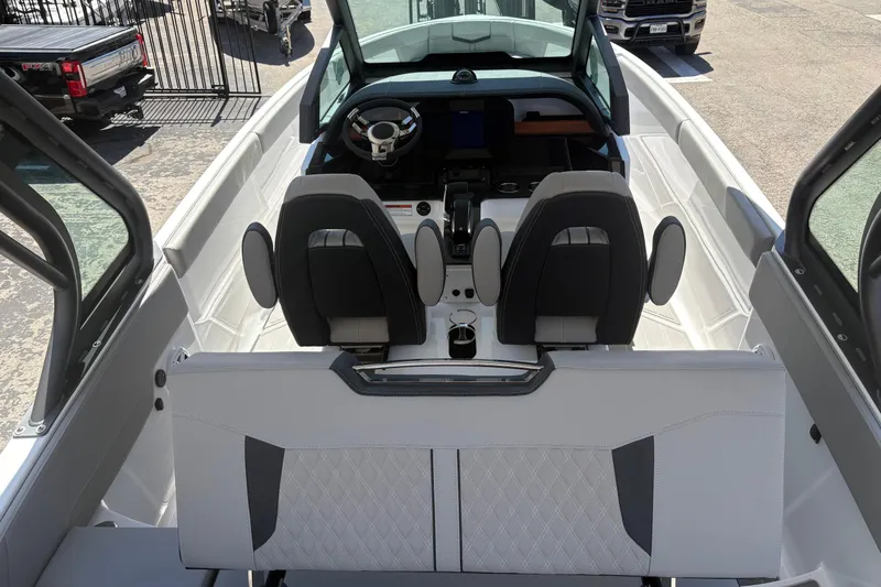 Slide: The Image of 2026 Monterey Elite 25 SD boat interior with modern seating and steering wheel. - 16