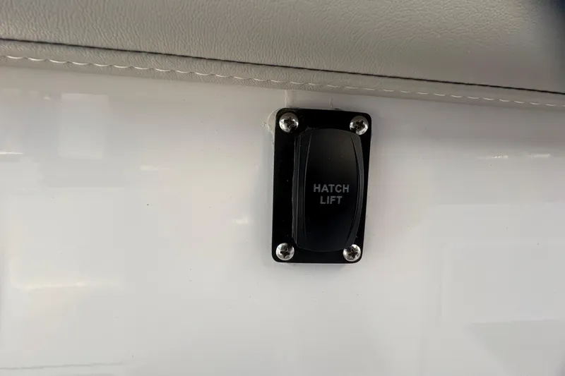Slide: The Image of Hatch lift switch on 2026 Monterey Elite 25 SD boat interior. - 19