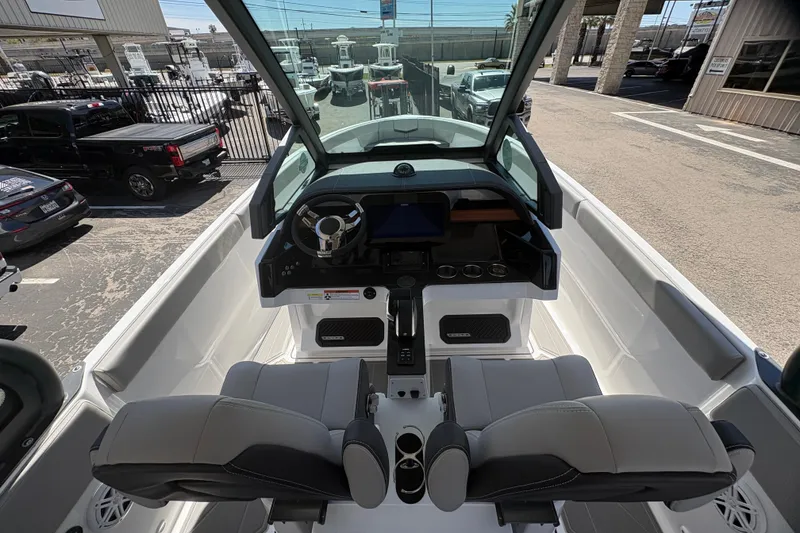 Slide: The Image of Interior view of 2026 Monterey Elite 25 SD boat with modern dashboard and seating. - 22