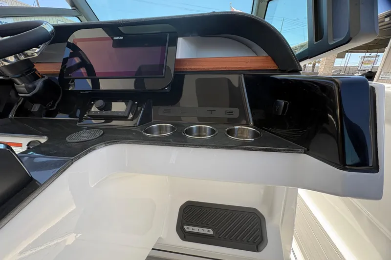 Slide: The Image of 2026 Monterey Elite 25 SD dashboard with touchscreen and cup holders. - 23