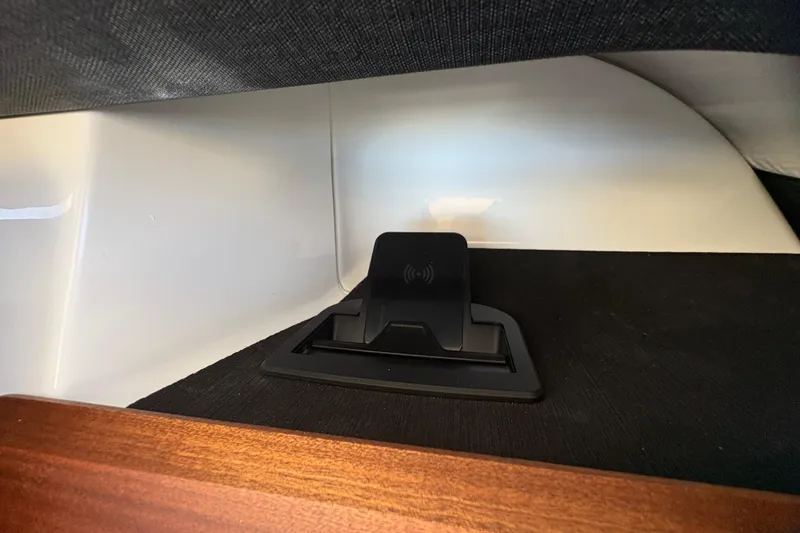 Slide: The Image of Wireless charging pad in 2026 Monterey Elite 25 SD boat interior. - 24