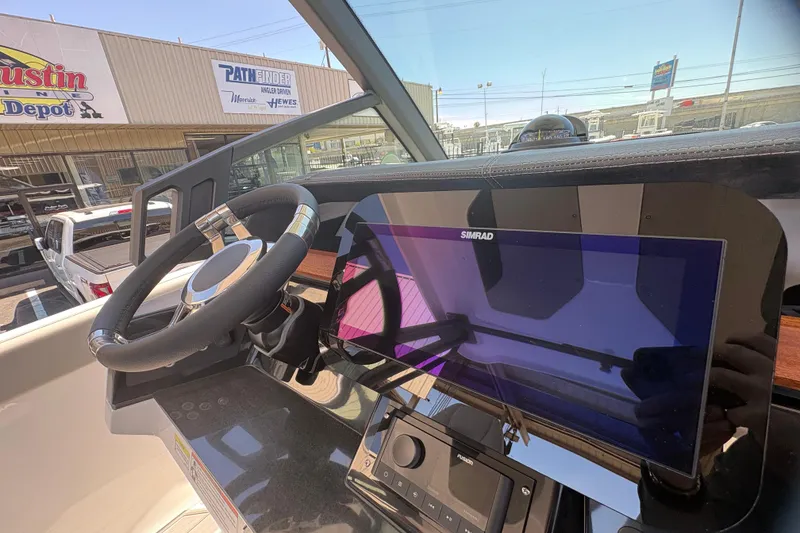 Slide: The Image of 2026 Monterey Elite 25 SD dashboard with steering wheel and Simrad display. - 28
