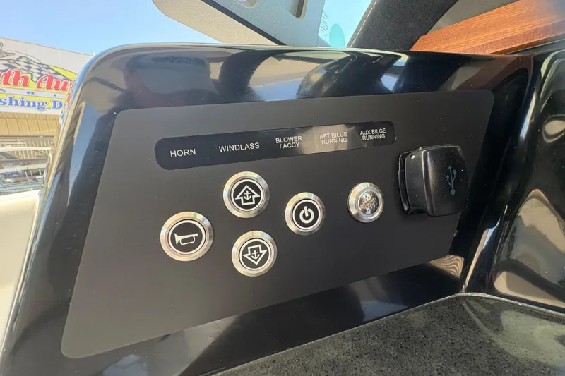 Slide: The Image of Control panel of 2026 Monterey Elite 25 SD boat with labeled buttons and USB port. - 30