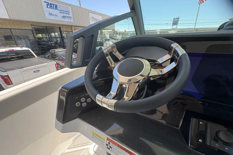 Slide: The Image of Steering wheel of 2026 Monterey Elite 25 SD boat, showcasing modern design and controls. - 31