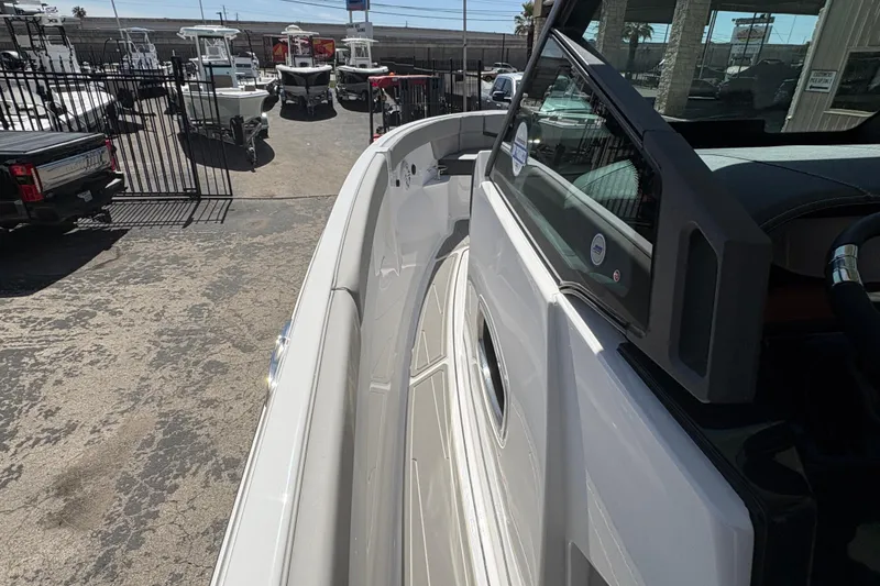Slide: The Image of 2026 Monterey Elite 25 SD boat in a dealership lot, showcasing sleek design and modern features. - 37