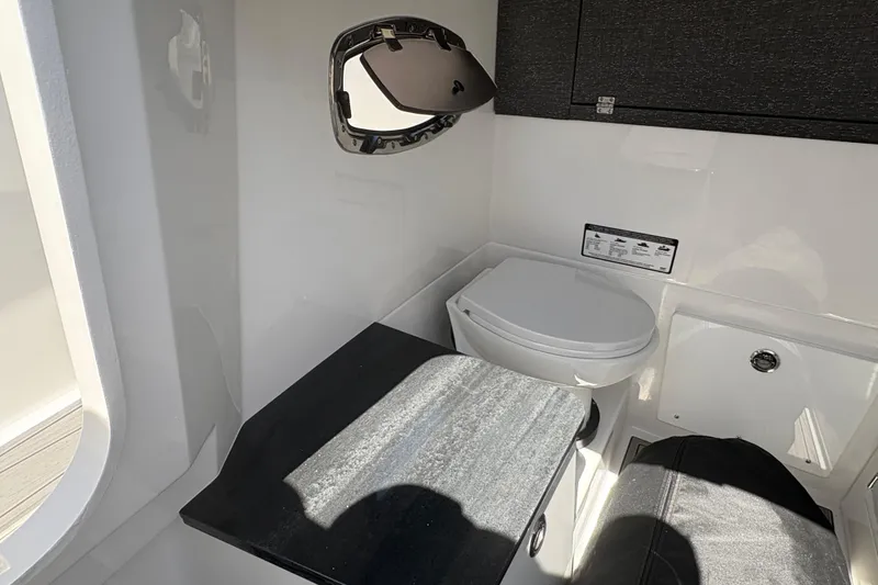 Slide: The Image of 2026 Monterey Elite 25 SD boat interior with compact bathroom and modern fixtures. - 42