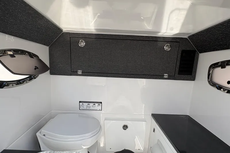 Slide: The Image of Interior of 2026 Monterey Elite 25 SD boat, featuring a compact bathroom setup. - 43