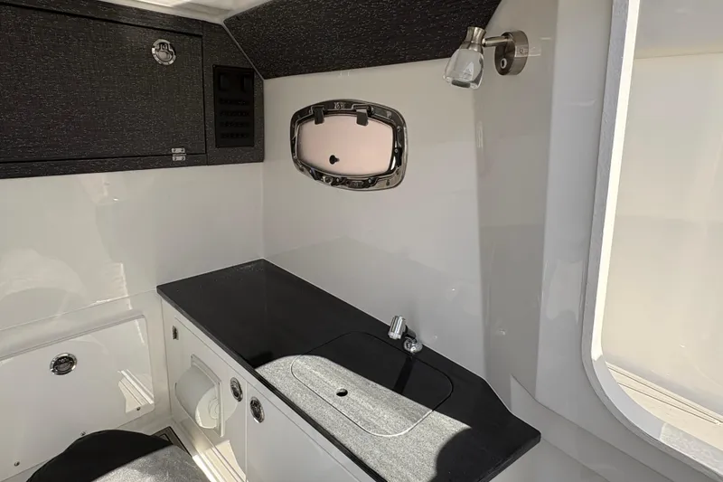 Slide: The Image of Interior of 2026 Monterey Elite 25 SD boat, featuring sleek countertop and modern fixtures. - 44
