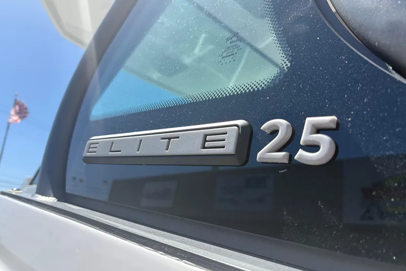 Slide: The Image of 2026 Monterey Elite 25 SD boat emblem close-up with clear sky background. - 8
