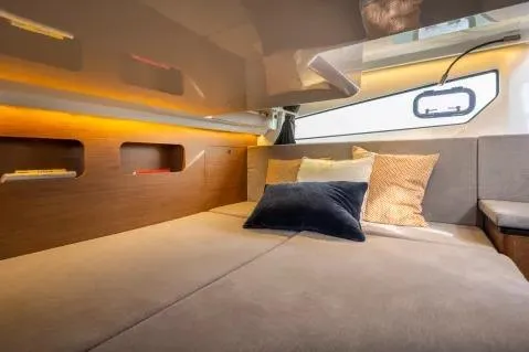 Slide: The Image of Interior cabin of 2026 Beneteau Antares 11 Fly with cozy bedding and modern design. - 14