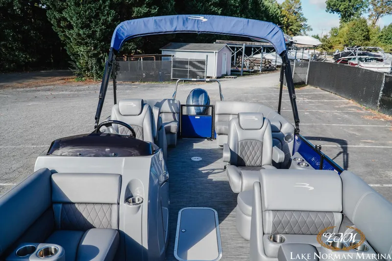 Slide: The Image of 2021 Bennington 22LSR pontoon boat with gray seating and blue canopy at Lake Norman Marina. - 12