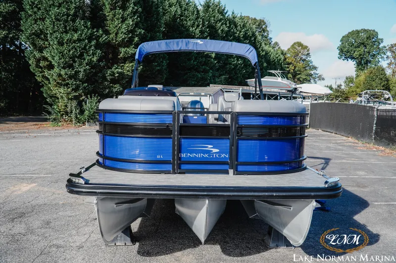 Slide: The Image of 2021 Bennington 22LSR pontoon boat at Lake Norman Marina, featuring sleek blue design. - 5