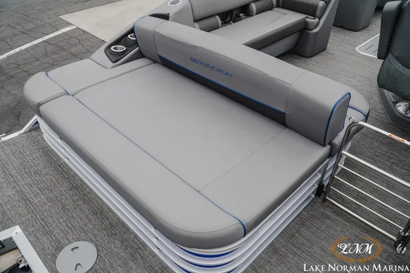 Slide: The Image of 2024 Bennington 23LSB boat interior with gray seating and cup holders at Lake Norman Marina. - 6