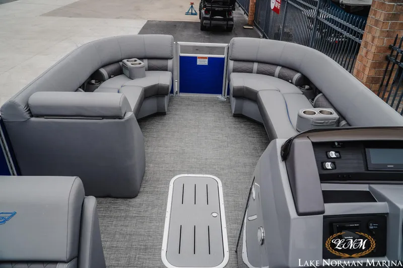 Slide: The Image of 2024 Bennington 23LSB pontoon boat interior with gray seating and modern dashboard. - 7