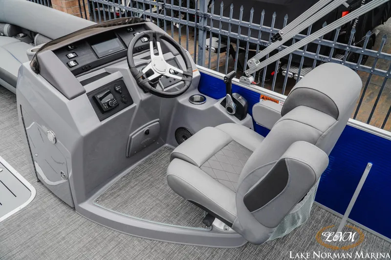 Slide: The Image of 2024 Bennington 23LSB boat helm with steering wheel and comfortable seating at Lake Norman Marina. - 8