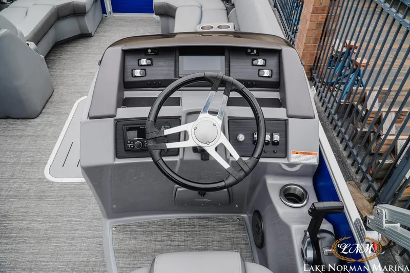 Slide: The Image of 2024 Bennington 23LSB boat helm with steering wheel and control panel at Lake Norman Marina. - 9