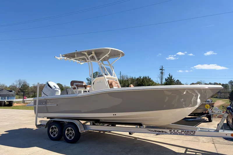 The Image of 2026 Pioneer 220 Bay Sport boat on trailer under clear blue sky. - 1