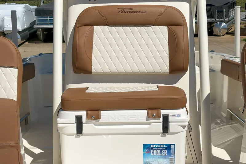 Slide: The Image of 2026 Pioneer 220 Bay Sport boat seat with Engel cooler, featuring brown and white upholstery. - 11