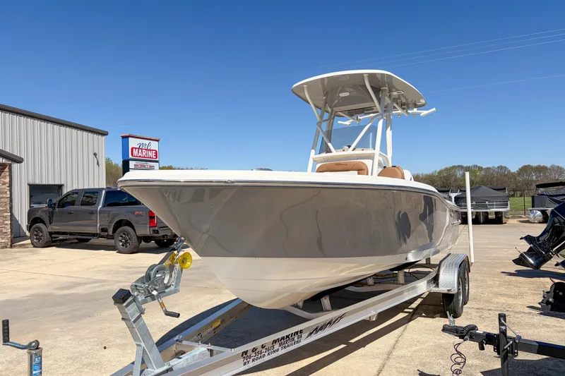 Slide: The Image of 2026 Pioneer 220 Bay Sport boat on trailer at dealership, clear sky background. - 12