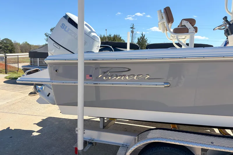 Slide: The Image of 2026 Pioneer 220 Bay Sport boat with Suzuki engine on trailer. - 2