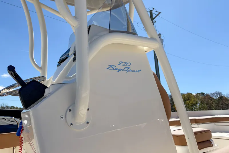 Slide: The Image of 2026 Pioneer 220 Bay Sport boat console with clear blue sky background. - 3
