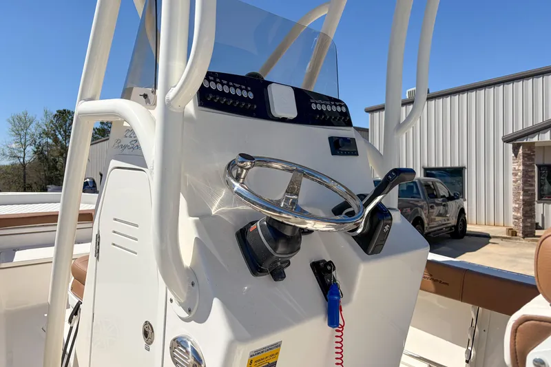 Slide: The Image of 2026 Pioneer 220 Bay Sport boat console with steering wheel and controls. - 7