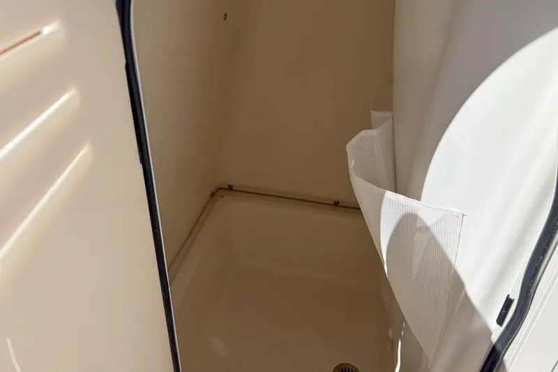 Slide: The Image of Interior compartment of 2026 Pioneer 220 Bay Sport boat, featuring storage space. - 9