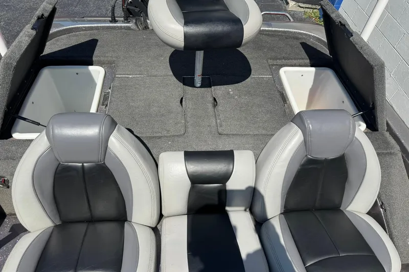 Slide: The Image of 2014 Skeeter TZX190 boat interior with gray and black seating and storage compartments. - 4