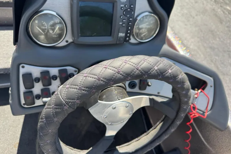 Slide: The Image of Steering wheel and dashboard of a 2014 Skeeter TZX190 boat. - 7