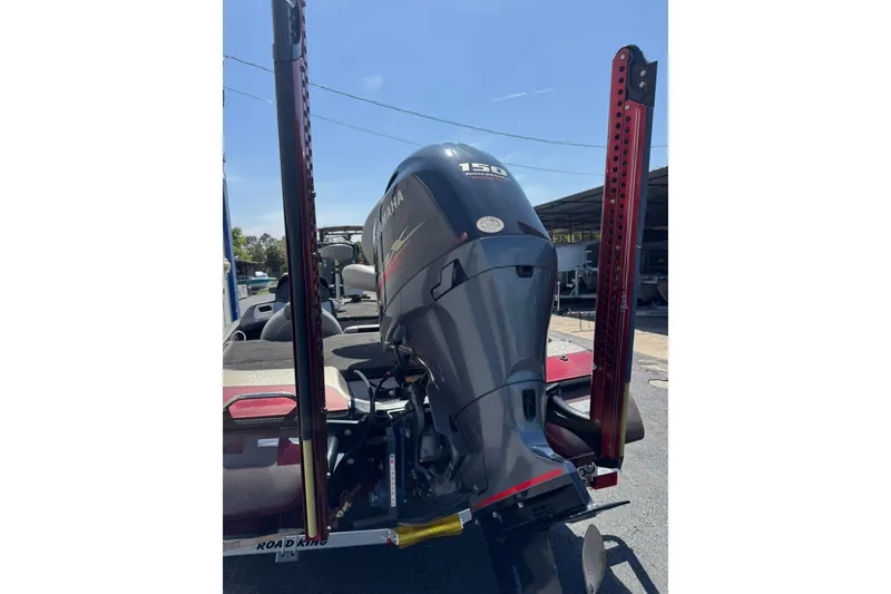 Slide: The Image of 2014 Skeeter TZX190 boat with Yamaha 150 engine, parked outdoors. - 9