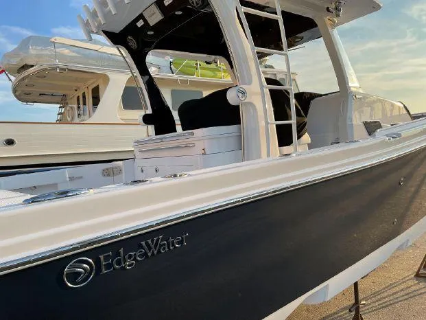 Slide: The Image of Edgewater 370CC 2020 boat docked, side view. - 10