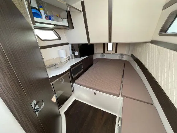 Slide: The Image of Interior of 2020 Edgewater 370CC with kitchenette and sleeping area. - 12