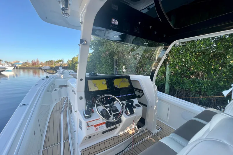 Slide: The Image of 2020 Edgewater 370CC boat cockpit with advanced navigation system and luxurious seating. - 18