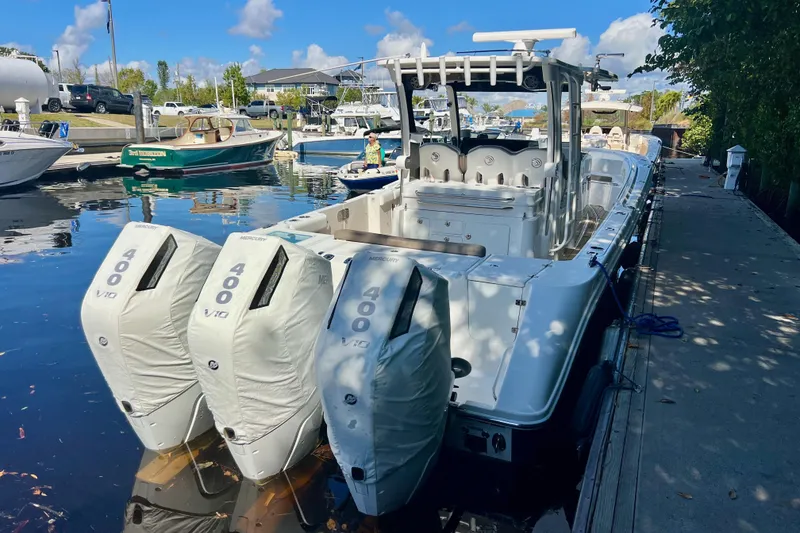 Slide: The Image of 2020 Edgewater 370CC boat docked with triple Mercury 400 V10 engines. - 2