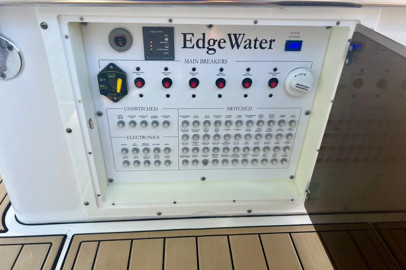 Slide: The Image of Edgewater 370CC 2020 boat control panel with main breakers and switches. - 23