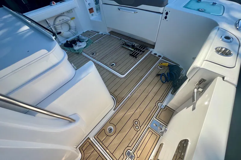 Slide: The Image of 2020 Edgewater 370CC boat interior with teak flooring and fishing gear. - 25