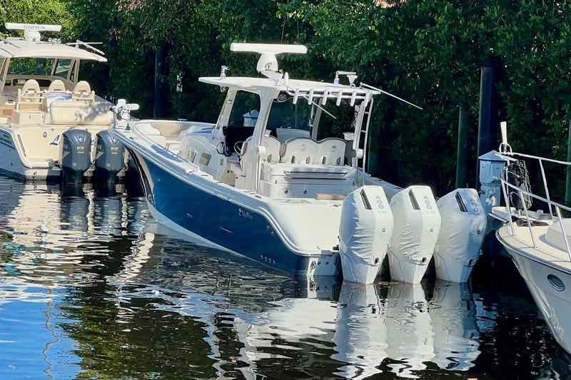 Slide: The Image of 2020 Edgewater 370CC boat docked with four outboard engines. - 3