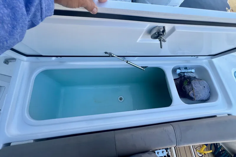 Slide: The Image of Open storage compartment on 2020 Edgewater 370CC boat, featuring a spacious interior. - 30