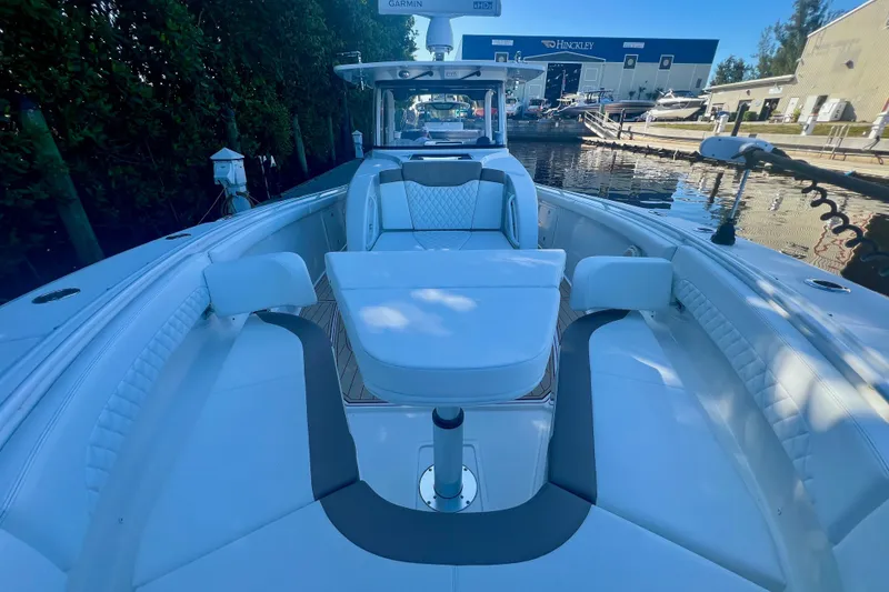 Slide: The Image of 2020 Edgewater 370CC boat interior with luxurious seating and modern design at a marina. - 33