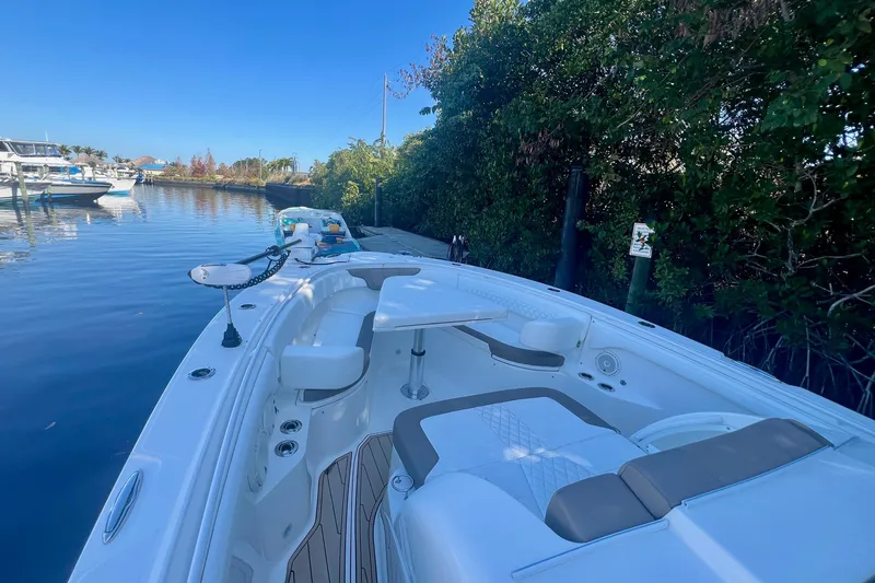Slide: The Image of 2020 Edgewater 370CC boat docked by lush greenery and calm waters. - 35