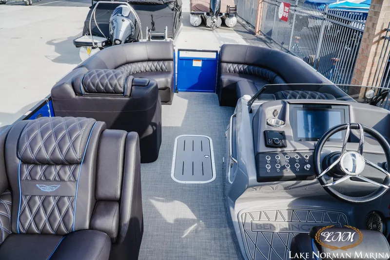 Slide: The Image of Luxurious 2025 Bennington 25QXSBA pontoon boat interior with plush seating and modern dashboard. - 10