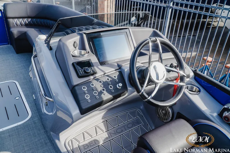 Slide: The Image of 2025 Bennington 25QXSBA boat dashboard with steering wheel and control panel. - 13