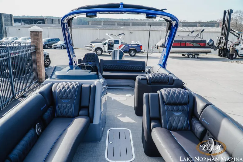 Slide: The Image of 2025 Bennington 25QXSBA pontoon boat with luxurious seating at Lake Norman Marina. - 17