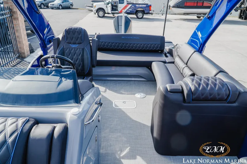 Slide: The Image of 2025 Bennington 25QXSBA pontoon boat interior with luxurious seating at Lake Norman Marina. - 20