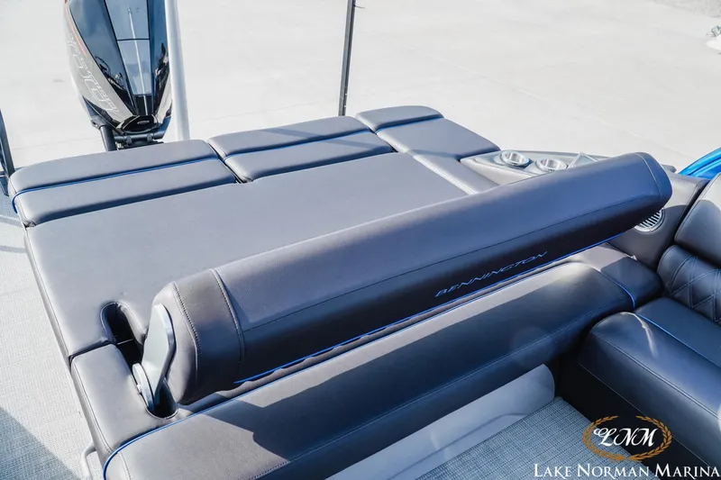 Slide: The Image of 2025 Bennington 25QXSBA boat with luxurious seating and sleek design at Lake Norman Marina. - 22