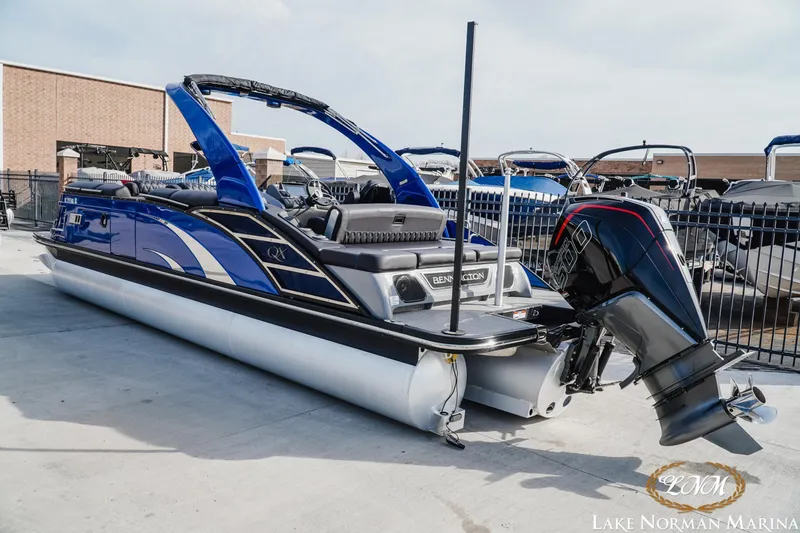 Slide: The Image of 2025 Bennington 25QXSBA pontoon boat with sleek blue design at Lake Norman Marina. - 3